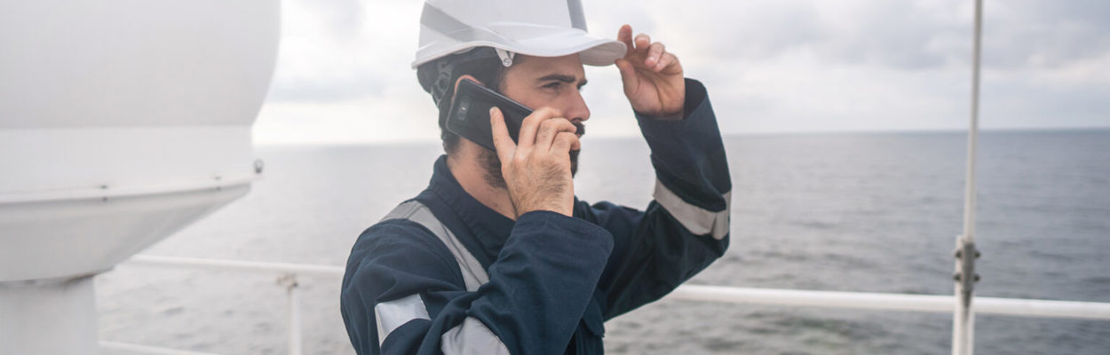 maritime worker ship satellite antenna on the phone