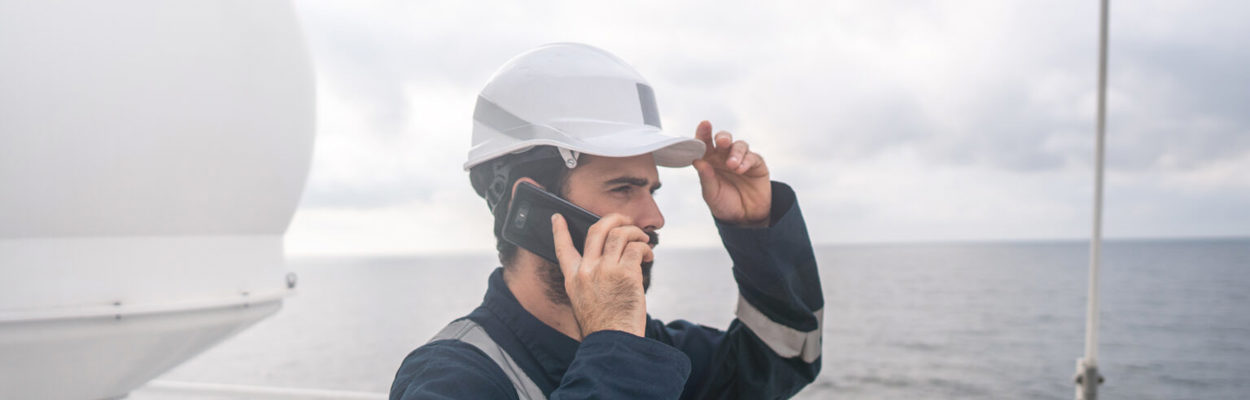 maritime worker ship satellite antenna on the phone