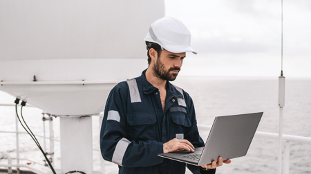 Crew using a computer on deck